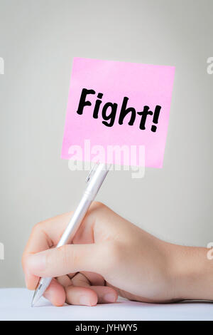 fight on working with hand holding pen Stock Photo