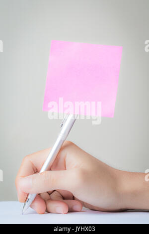 blank pink notepad stick with pen Stock Photo