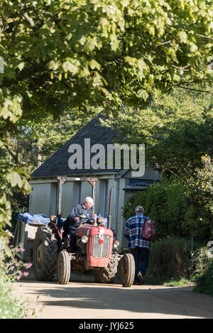 A farmer stops for a chat with his neighbour on the Isle of Sark, Bailiwick of Guernsey in the Channel Islands, Britain. Stock Photo