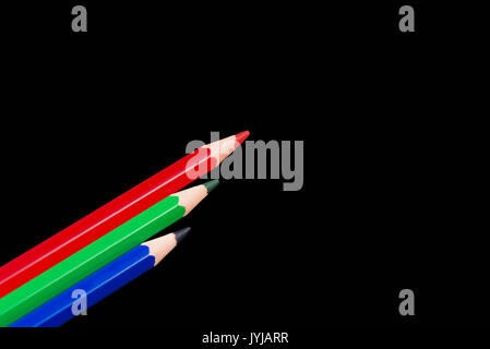 Red Green & Blue Pencils set in a row and isolated on a black back ground. Three RGB colours. Stock Photo