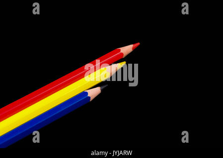 Red Yellow & Blue Pencils set in a row and isolated on a black back ground. Three colours Red Yellow & Blue. Three RGB colours. Stock Photo