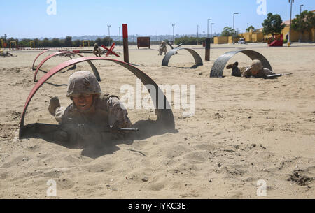 Recruits from Charlie Company, 1st Recruit Training Battalion, crawl through tunnels during the Bayonet Assault Course at Marine Corps Recruit Depot San Diego, Aug. 8. The recruits had to depend on the their other fire team members and try to stay together through the entire course while trying to move fast enough so as not to hinder the progress of other teams. Annually, more than 17,000 males recruited from the Western Recruiting Region are trained at MCRD San Diego. Charlie Company is scheduled to graduate Sept. 1. Stock Photo