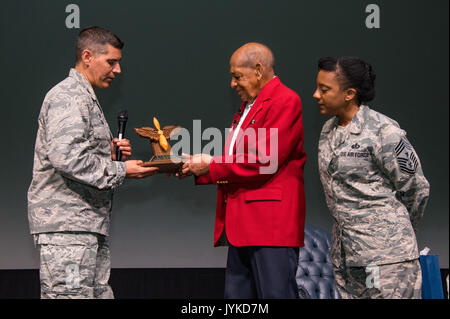 Maxwell AFB, Ala. – 42nd Air Base Wing commander Colonel Eric Shafa (left) and Command Chief Master Sergeant Erica Shipp (right) present former Tuskegee Airman retired Lieutenant Colonel Harold Brown with a commemorative Prop and Wings statuette. (US Air Force photo by Melanie Rodgers Cox/Released) Stock Photo