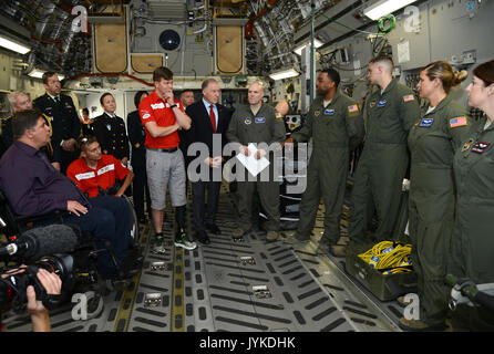 Members of the 86th Medical Squadron's Critical Care Air Transportation Team talks about the air medical evacuation process Aug. 15, 2017 with Invictus Games Toronto 2017 Team Canada members Cpl. (retired) Chris Klodt, and co-captain Maj. Simon Mailloux, who were both medically evacuated to Landstuhl Regional Medical Center after being wounded in battle. Canada’s Minister of Veteran Affairs Honourable Kent Hehr and his Deputy Minister General (Retired) Walter Natynczyk joined the visit to Ramstein Air Base and LRMC. (U.S. Army photo by Visual Information Specialist Elisabeth Paque/Released) Stock Photo