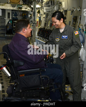 Lt. Col. Lynn Hay, Assistant Director of Operations for the 86th Aeromedical Evacuation Squadron, explains how her team unloads patients from an aircraft, Aug. 15, 2017 to Canada’s Minister of Veteran Affairs Honourable Kent Hehr during his visit to Ramstein Air Base, Germany. (U.S. Army photo by Visual Information Specialist Elisabeth Paque/Released) Stock Photo