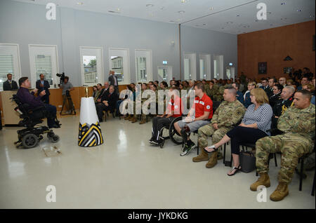 Canada’s Minister of Veteran Affairs Honourable Kent Hehr addresses a large crowd gathered at LRMC, Aug. 15, 2017 for the symbolic arrival of the Invictus Games Spirit Flame from Afghanistan to Germany, making a similar journey many Landstuhl Regional Medical Center patients make after being wounded in battle. Two former patients from Canada, Invictus Games Toronto 2017 Team Canada co-captain Maj. Simon Mailloux and teammate Cpl. (retired) Chris Klodt brought the flame to LRMC, where they were treated after being wounded in battle. (U.S. Army photo by Visual Information Specialist Elisabeth Pa Stock Photo