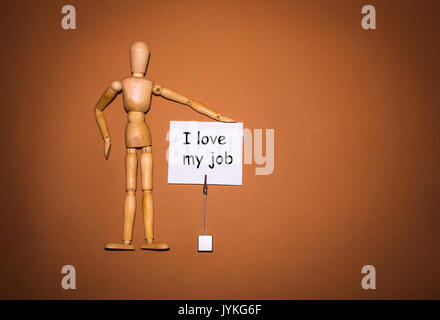 Wooden man with hand, holding the holder Stock Photo