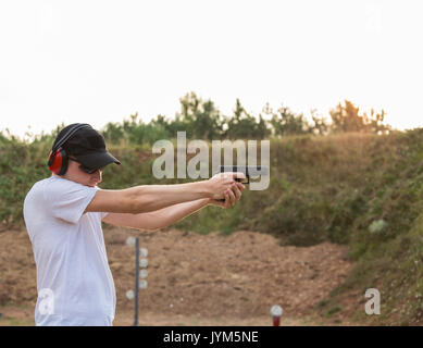 Military personnel training outside with special forces and police to stop criminals with guns and firearms shooting at the target bullet flying from  Stock Photo