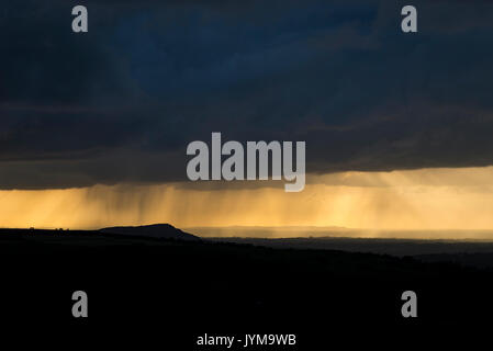 Rain clouds at sunset over the Cheshire countryside, England. Viewed from the Roaches in Staffordshire. Stock Photo