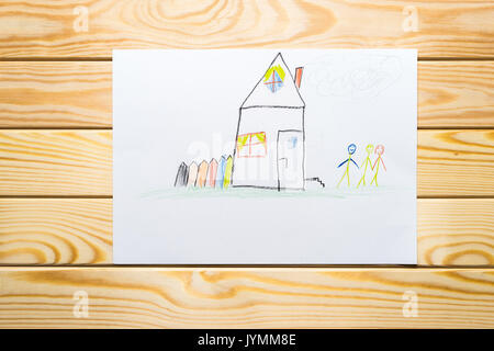 child's drawing. home and happy family wooden background Stock Photo