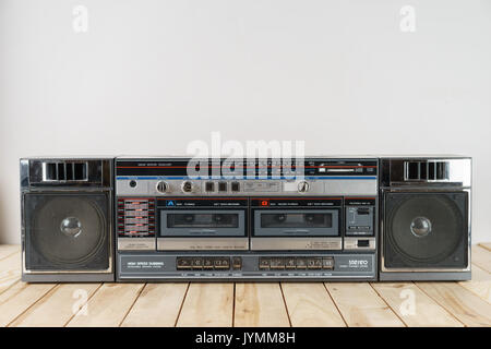 vintage audio cassette tape deck ghettoblaster on wooden table.