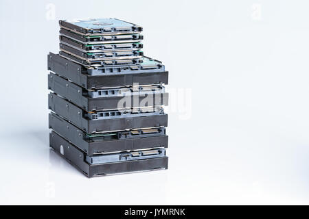 pile of old hard drives at white background Stock Photo
