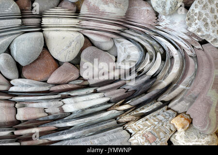 Water ripples above pebble stones - digitally altered Stock Photo