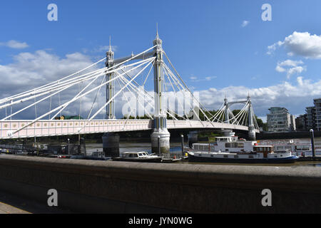 London: Albert Bridge in Chelsea on a sunny day. From the north bank of the Thames looking south to Battersea. Stock Photo