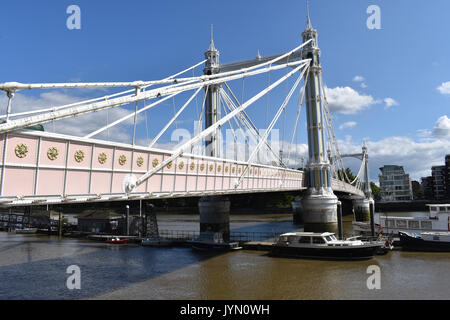 London: Albert Bridge in Chelsea on a sunny day. From the north bank of the Thames looking south to Battersea. Stock Photo