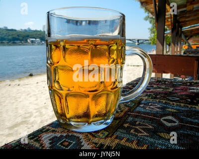 Cold beer mug with handle on table Stock Photo