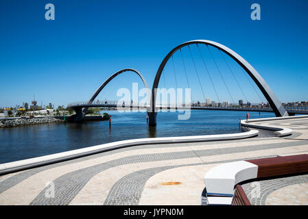 People walking across Elizabeth Quay Bridge in Perth City, Western Australia Stock Photo