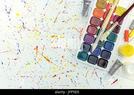 top view of palette with Gouache paints and paintbrush on white background  Stock Photo by LightFieldStudios