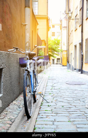 Stockholm's street with bicycle near a wall, Sweden Stock Photo