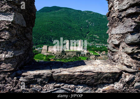 Castlegrande framed by ruined stone of Montebello Castle, Three Castles of Bellinzona, Ticino, Switzerland. Stock Photo