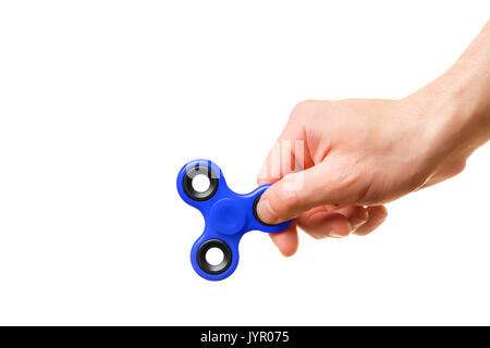 A man's hand holds a blue spinner on a white background Stock Photo