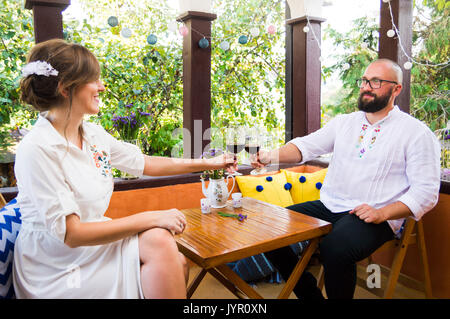 Couple toasting with a glass of wine on a date Stock Photo
