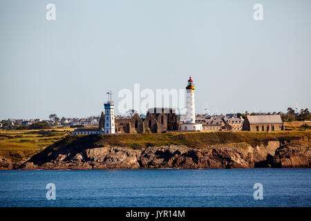 View of the Brittany headlands and the Abbaye Saint-Mathieu de fine Terre and Saint-Mathieu lighthouse seen from a ship in the Bay of Biscay France Stock Photo