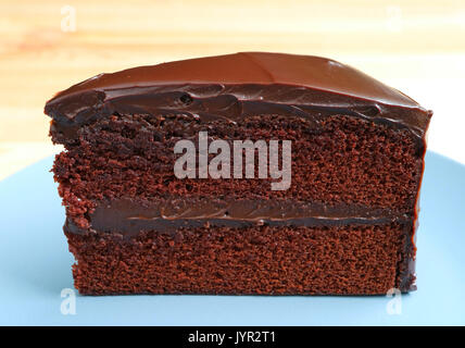Front view of Chocolate Layer Cake Served on Wooden Table, Blurred Background Stock Photo