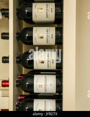 Red wine bottles in a rack from the Bordeaux region of France, including Saint Julien and Saint Emilion Stock Photo