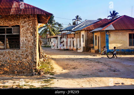 Zanzibar, Tanzania - January 8, 2016: Young boy playing in front of their houses in Jambiani village (Zanzibar). Stock Photo