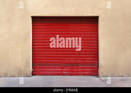 Closed red garage metal roller door exterior Stock Photo