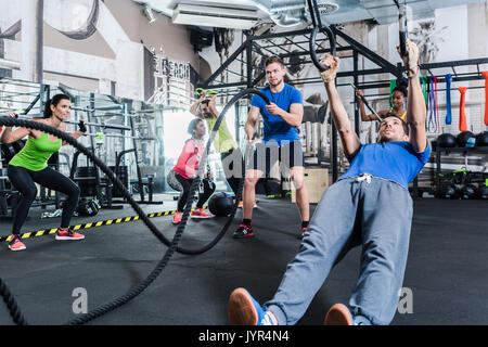 Men and women at functional fitness training in gym Stock Photo