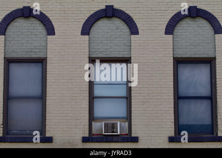 Three windows from a nineteenth century brick building Stock Photo