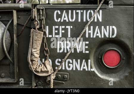 'Caution Left Hand Drive No Signal' at the rear of a military vehicle Stock Photo