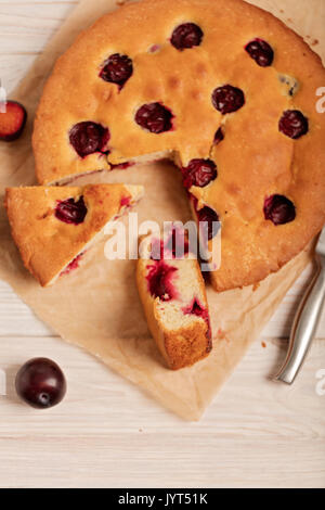 Home plum pie on baking paper. Selective focus. Stock Photo