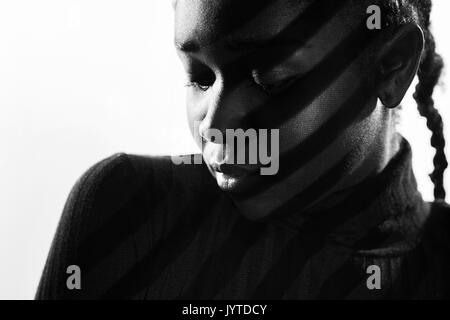 Creative stripes from projection light on beautiful woman with dark skin Stock Photo