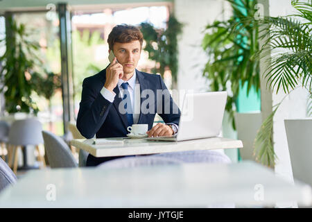 Contemporary Businessman Working in Cafe Stock Photo