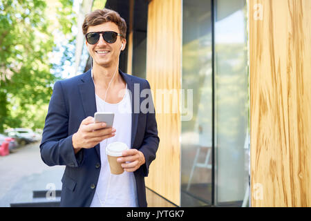 Handsome Young Man Enjoying Walk in City Stock Photo