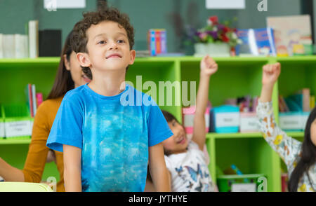 Kindergarten students stand up in classroom,preschool international education concept. Stock Photo