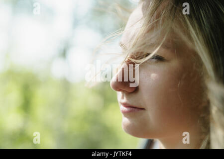 young girl traveling in car portrait with wind blowing her hair Stock Photo