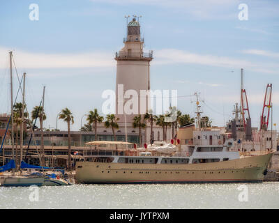 MALAGA, SPAIN - MARCH 09, 2016:  Port and Lighthouse and luxury yacht in the harbour that is now a Marina Stock Photo