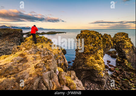 Snaefellsness peninsula, Iceland. Man standing over a rock formation along the coast. Stock Photo