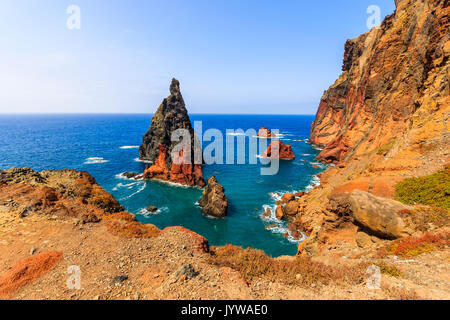 High cliffs with rocks in ocean on coast of Madeira island at Ponta de Sao Lourenco, Portugal Stock Photo
