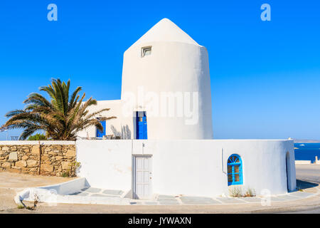 White windmill along road to Mykonos port, Mykonos island, Greece Stock Photo