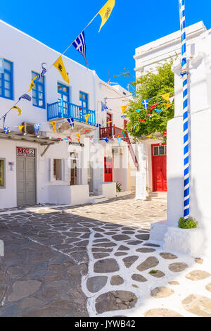 MYKONOS TOWN, GREECE - MAY 17, 2016: Typical street of beautiful Mykonos town with white and blue Greek architecture, Cyclades islands, Greece. Stock Photo