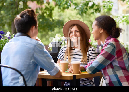 Students Chatting at Lunch in Cafe Outdoors Stock Photo