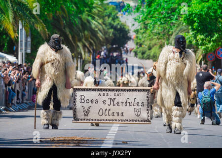 Sardinia traditional festival, men dressed as Boes and Merdules - traditional figures in sheepskins and masks, participate in La Cavalcata, Sassari. Stock Photo