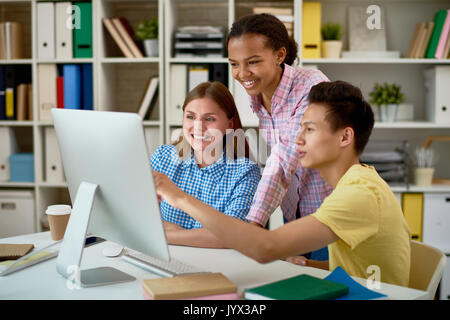 Smiling Students Working with Computer Stock Photo