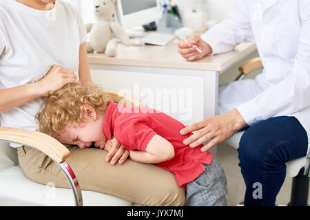 Little Boy Crying in Doctors Office Stock Photo