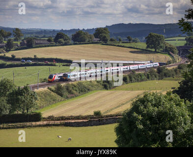 First Transpennine express class 350 and a Virgin Trains Pendolino pass at  Rowell  (between Carnforth & Oxenholme)  on the West Coast main line Stock Photo